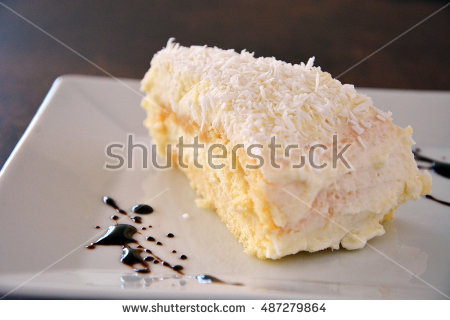 stock-photo-coconut-cake-on-brown-table-487279864.jpg